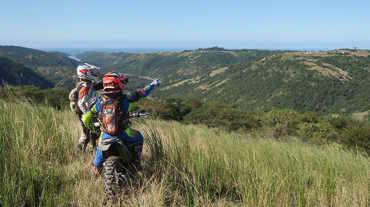Motorbike riders pointing out to the transkei landscape